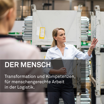 Woman with laptop in high rack warehouse